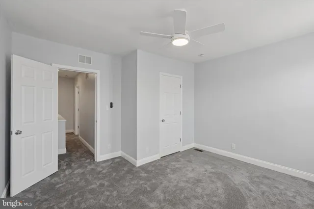 a view of an empty room and closet area
