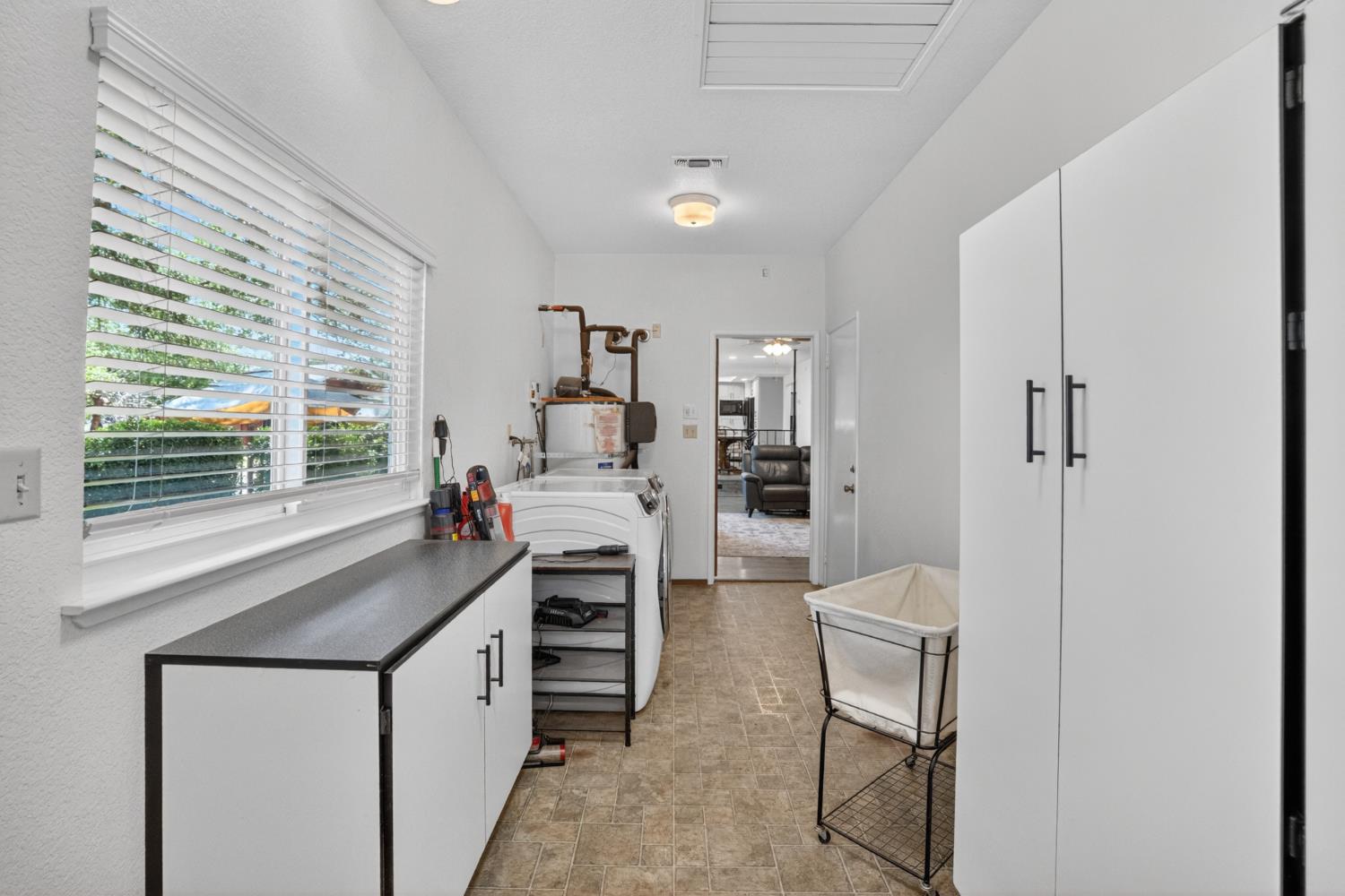 13088 Cherry Road Wilton, CA 95693 - Photo 29 of 58 Laundry room with 1.2 bath and exit to backyard.