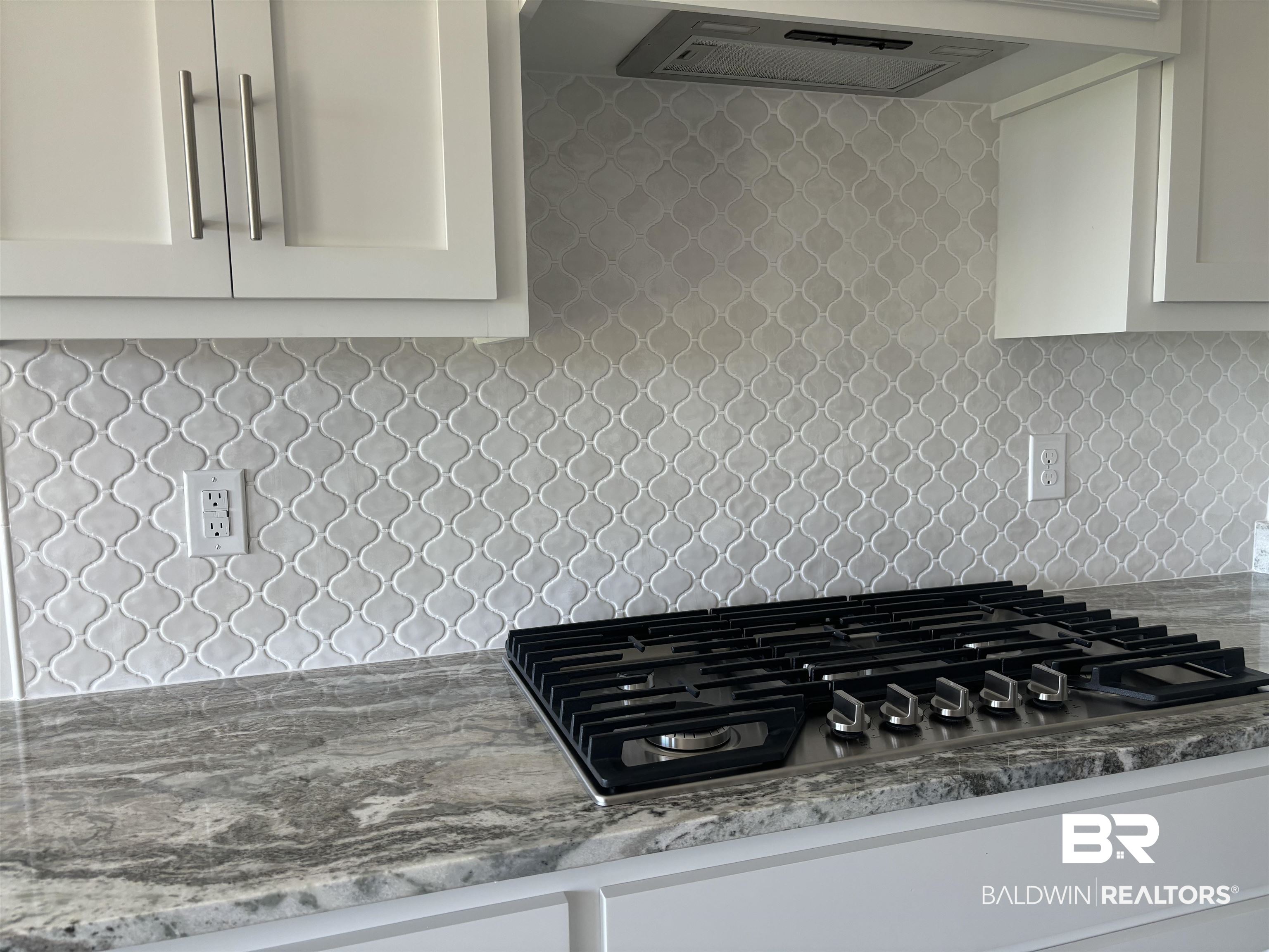 388 Garrison Boulevard Fairhope, AL 36532 - Photo 13 of 34 Kitchen with ventilation hood, light stone countertops, gas stovetop, and decorative backsplash