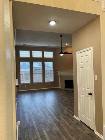 wooden floor in an empty room with a fireplace