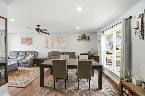 a view of a dining room with furniture window and wooden floor