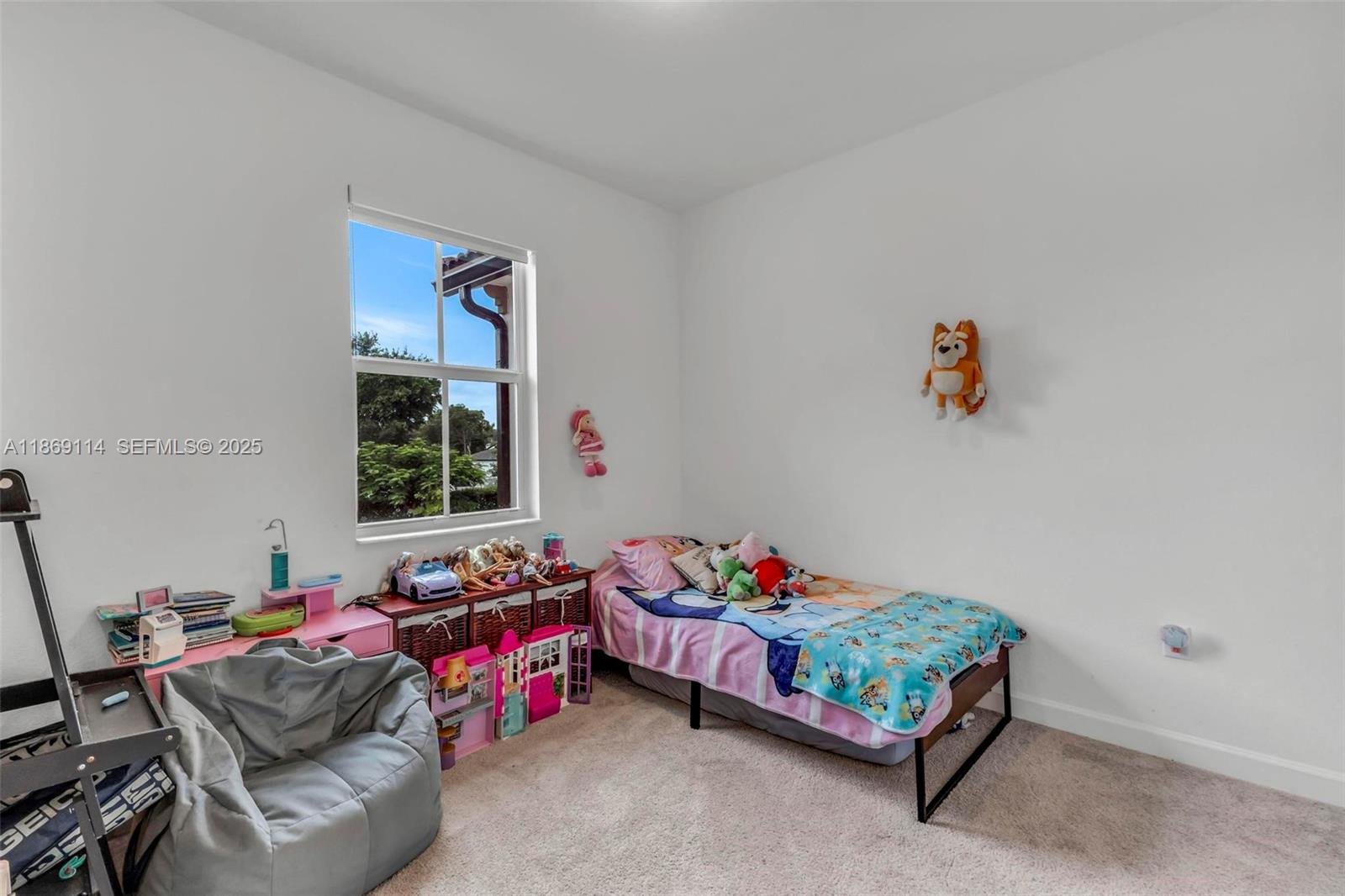 12774 Northwest 22nd Place Miami, FL 33167 - Photo 12 of 32 a bedroom with a bed and a window