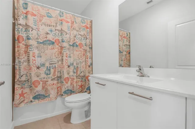a bathroom with a granite countertop sink a toilet and a shower