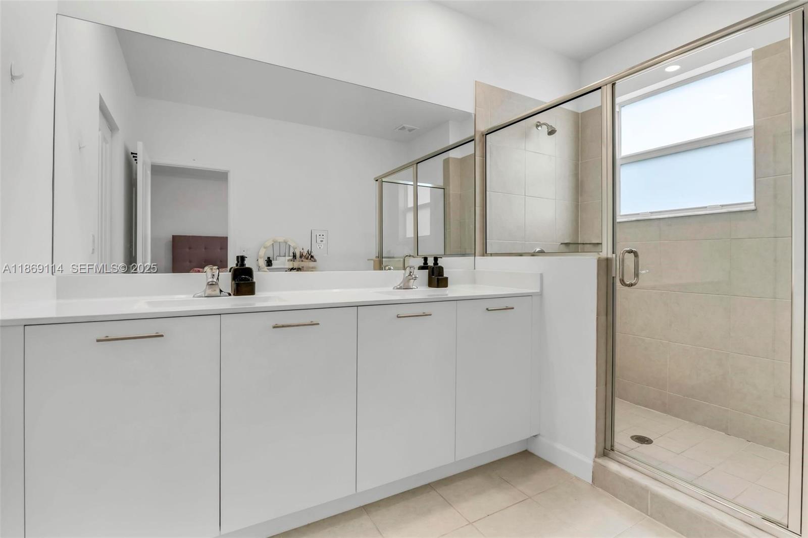 12774 Northwest 22nd Place Miami, FL 33167 - Photo 16 of 32 a bathroom with a double vanity sink mirror and shower