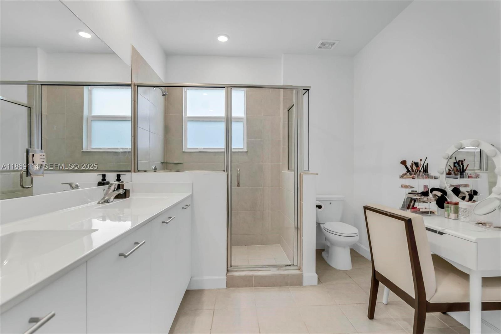 12774 Northwest 22nd Place Miami, FL 33167 - Photo 17 of 32 a spacious bathroom with a double vanity sink a toilet and a shower