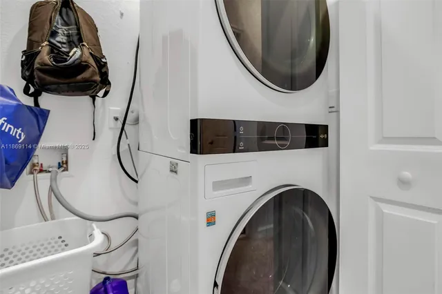a utility room with dryer washer and a mirror