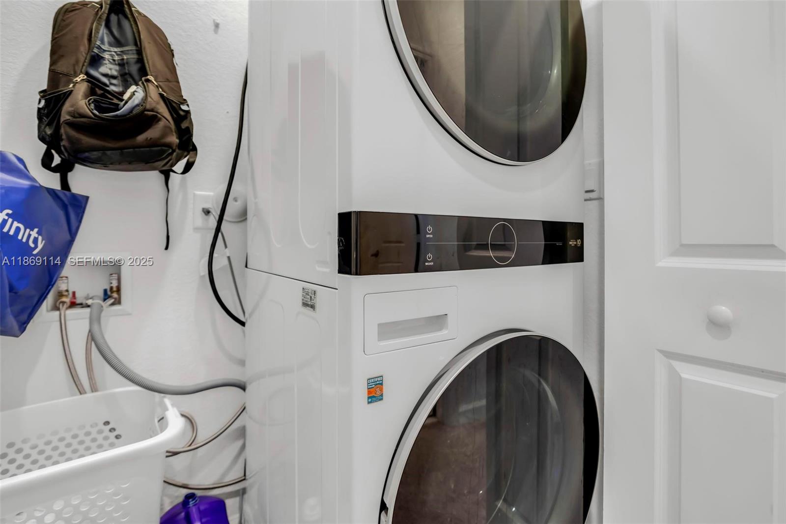 12774 Northwest 22nd Place Miami, FL 33167 - Photo 18 of 32 a utility room with dryer washer and a mirror
