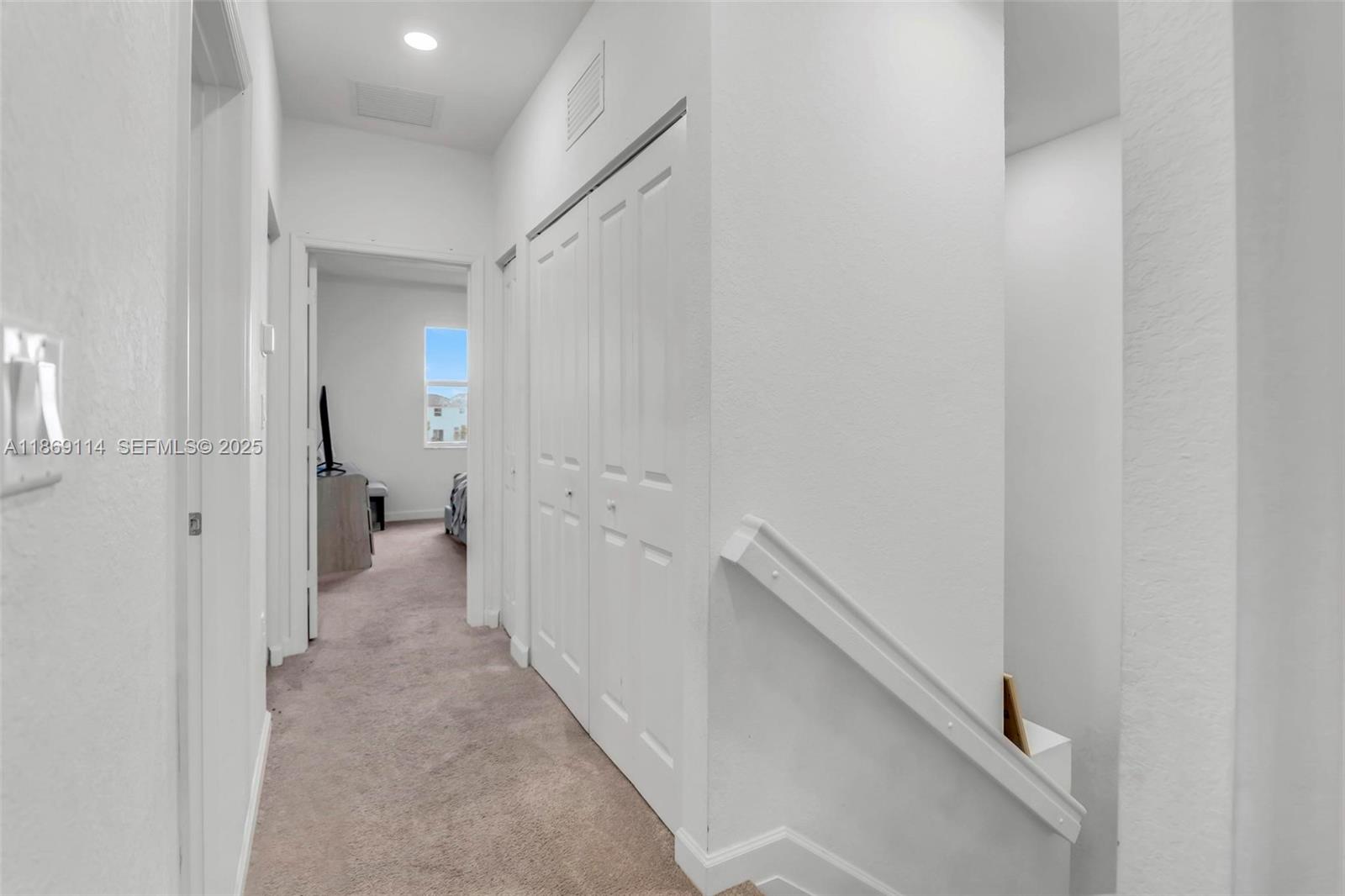 12774 Northwest 22nd Place Miami, FL 33167 - Photo 19 of 32 a view of a hallway with two windows