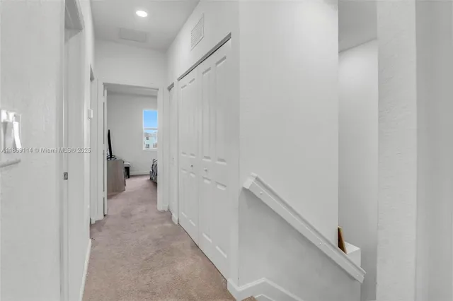 a view of a hallway with two windows