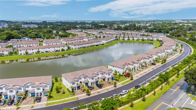 an aerial view of a house with a garden and lake view