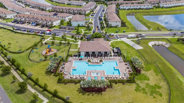 an aerial view of a house with a garden and swimming pool