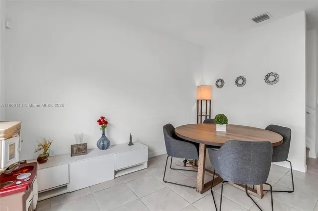 a living room with furniture and a sink
