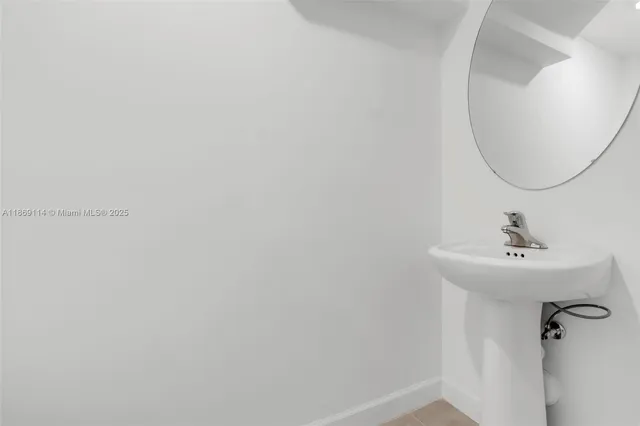 a bathroom with a sink and mirror