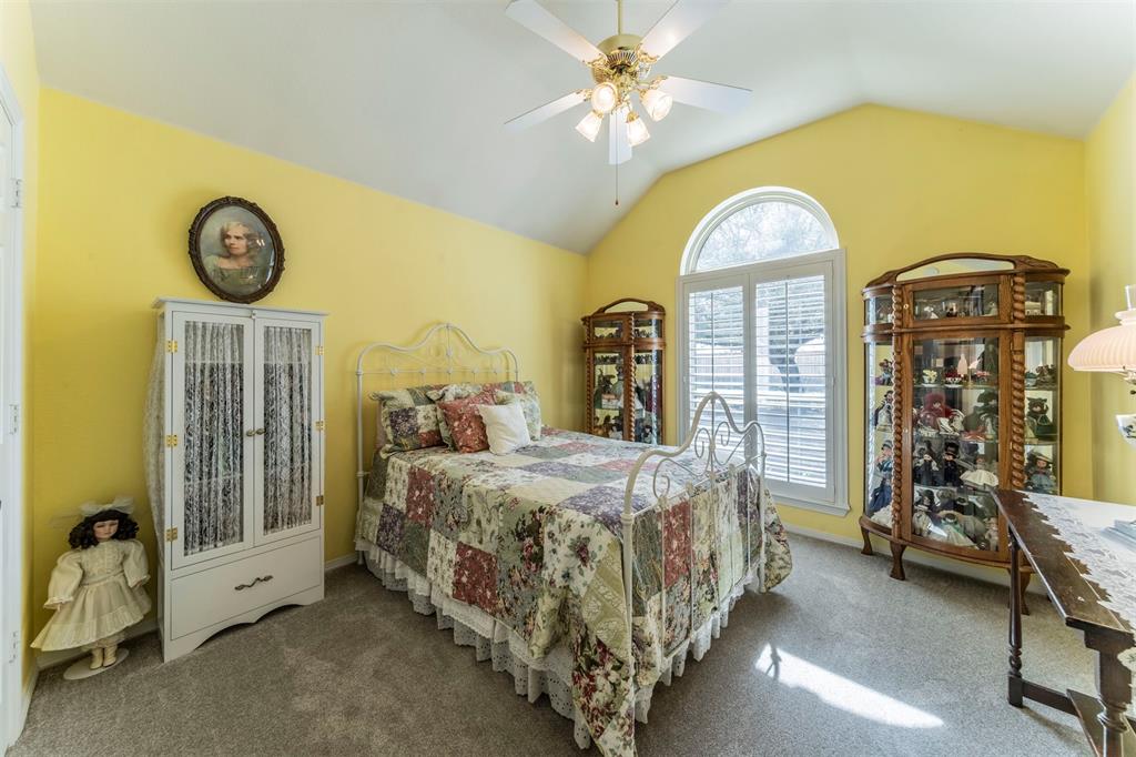 11621 Willow Springs Road Fort Worth, TX 76052 - Photo 11 of 35 a bed sitting in a room next to a window