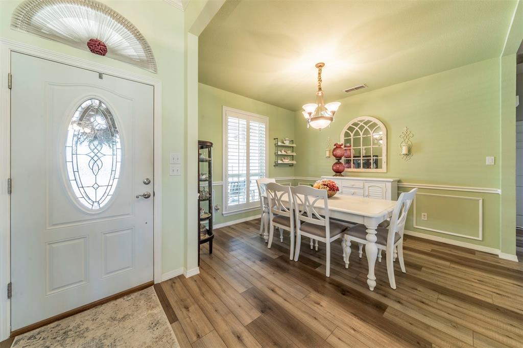 11621 Willow Springs Road Fort Worth, TX 76052 - Photo 14 of 35 a view of a dining room with furniture window and wooden floor