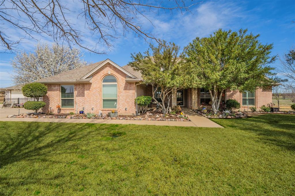 11621 Willow Springs Road Fort Worth, TX 76052 - Photo 17 of 35 a front view of a house with a garden and porch