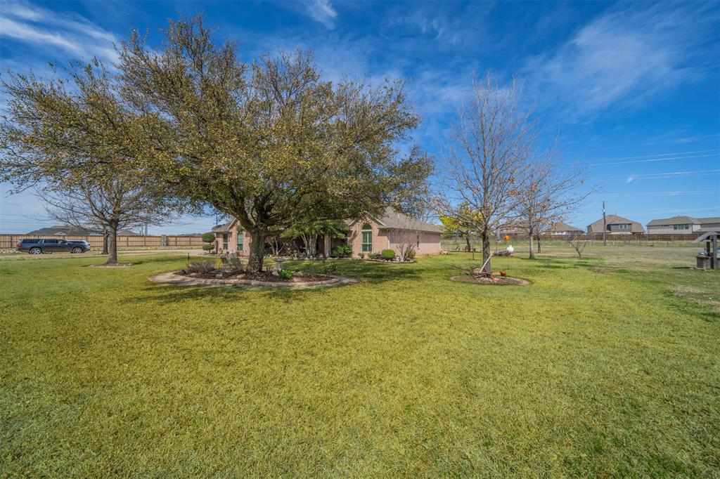 11621 Willow Springs Road Fort Worth, TX 76052 - Photo 18 of 35 a view of a swimming pool and trees in the background