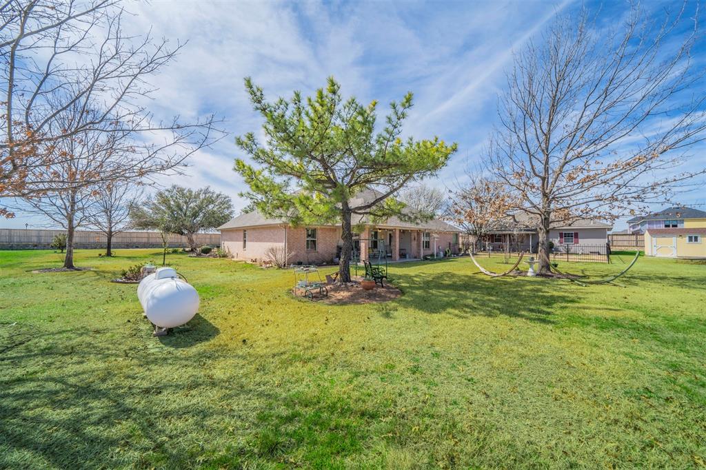11621 Willow Springs Road Fort Worth, TX 76052 - Photo 21 of 35 a backyard of a house with table and chairs