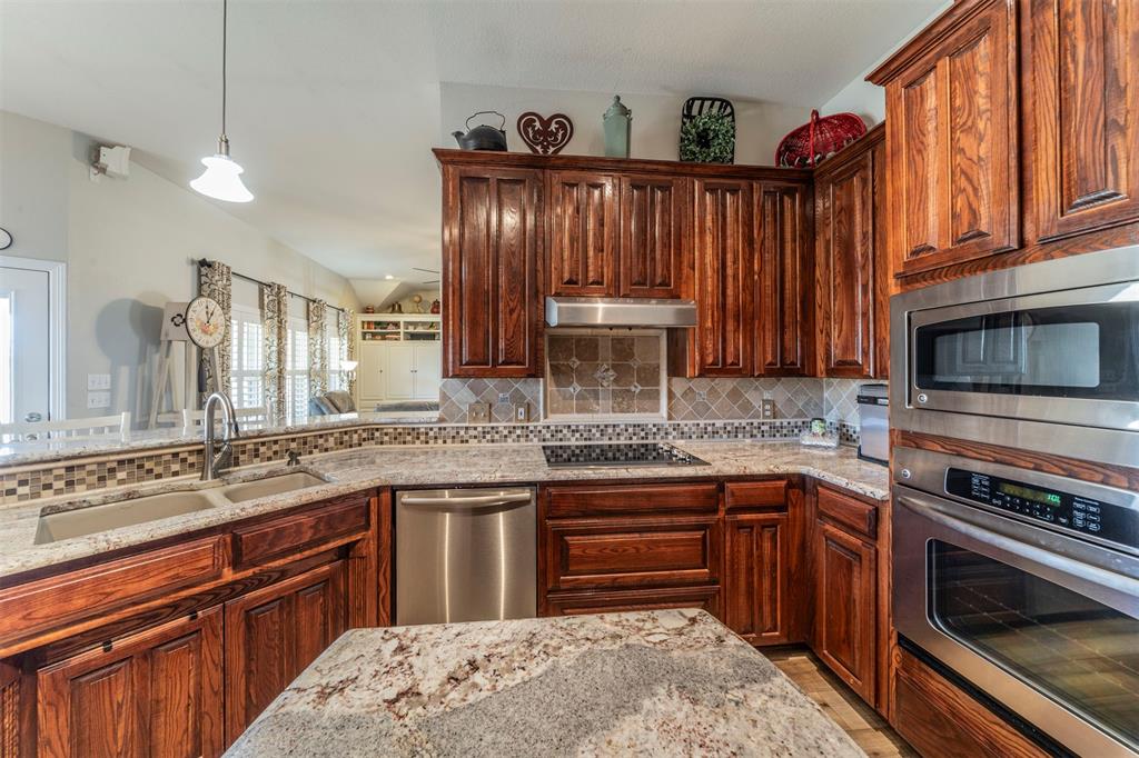 11621 Willow Springs Road Fort Worth, TX 76052 - Photo 4 of 35 a kitchen with stainless steel appliances granite countertop a stove sink and cabinets