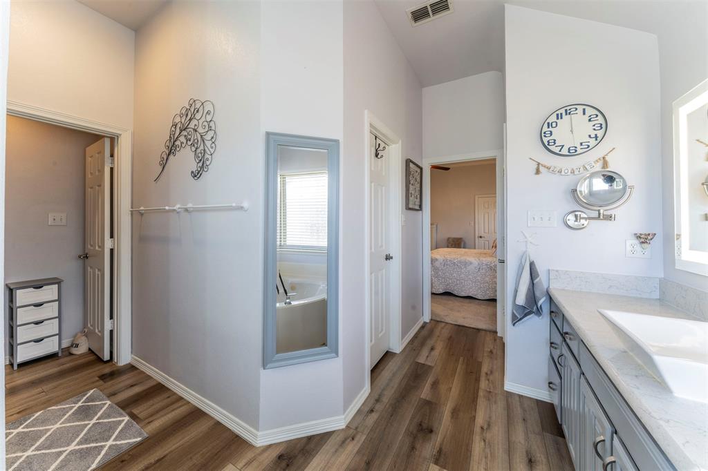 11621 Willow Springs Road Fort Worth, TX 76052 - Photo 10 of 35 a spacious bathroom with a glass door shower and a sink