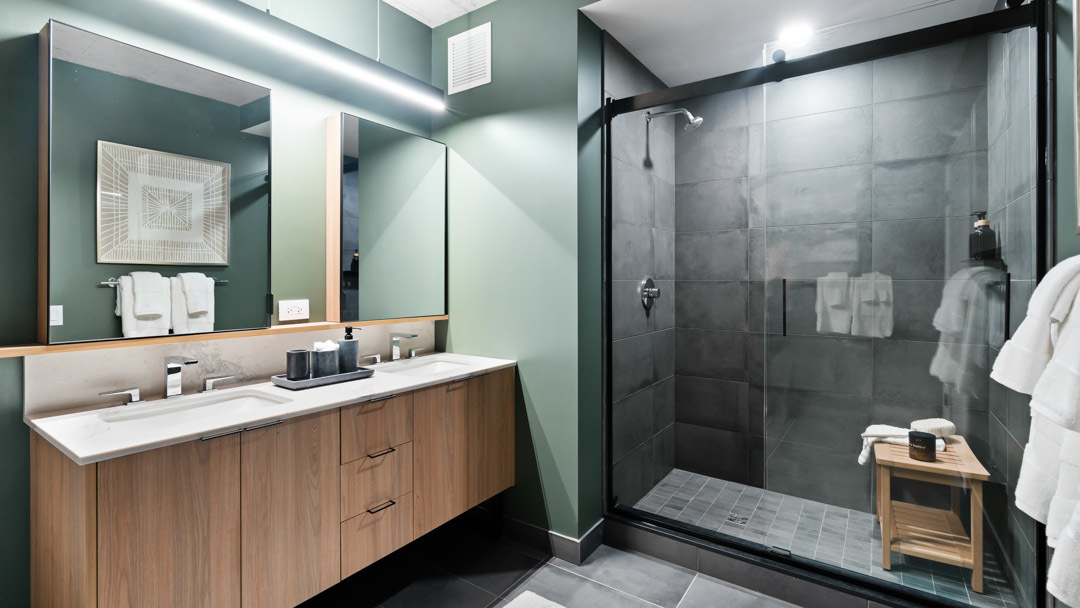 234 West Polk Street, Unit 2708 Chicago, IL 60607 - Photo 5 of 16 a bathroom with a double vanity sink mirror and shower