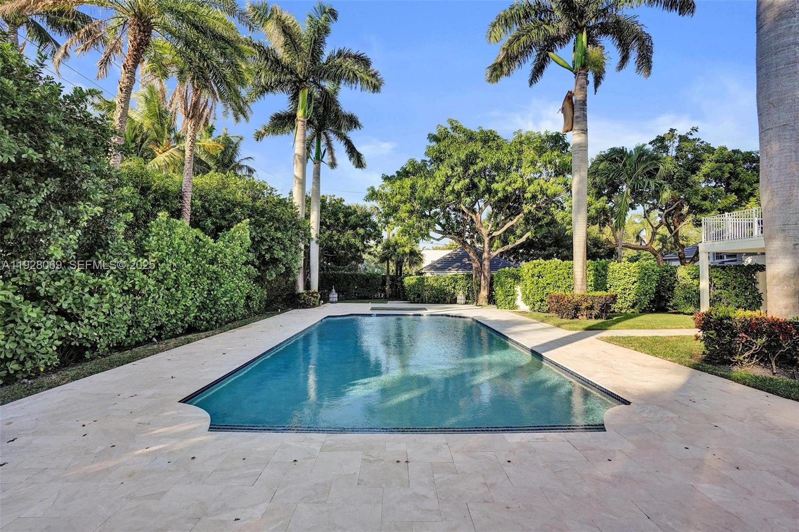 1281 Banyan Road Boca Raton, FL 33432 - Photo 24 of 69 a view of a swimming pool with a garden