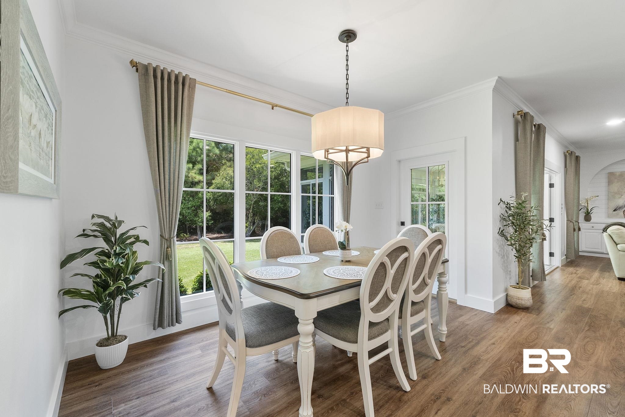 4451 Millhouse Road Gulf Shores, AL 36542 - Photo 17 of 50 Dining area featuring ornamental molding and hardwood / wood-style flooring