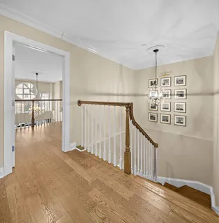 a view of a hallway with wooden floor and entryway