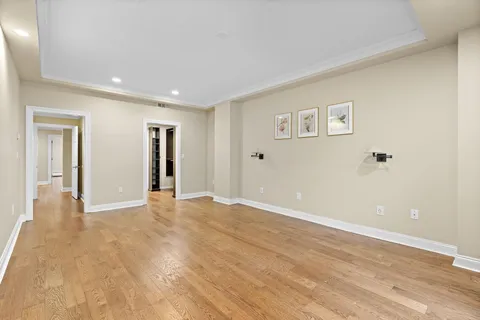 a view of an empty room with wooden floor