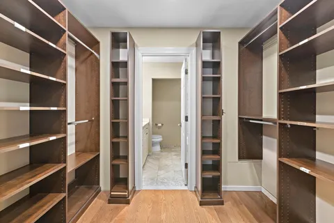 a view of walk in closet with empty racks