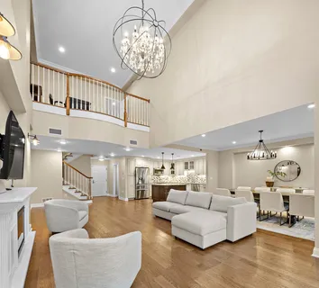 a living room with furniture and a chandelier