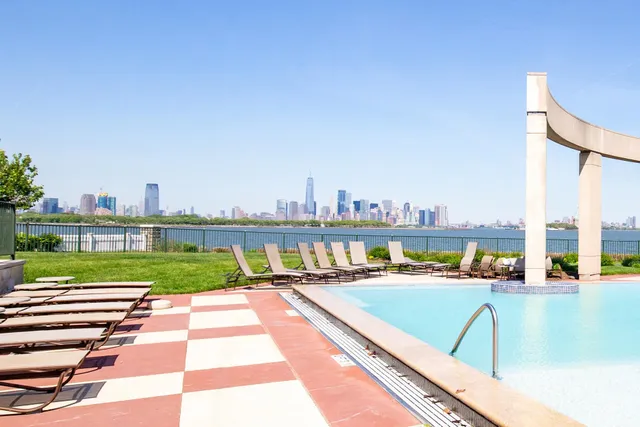 a view of swimming pool with a chairs and a table