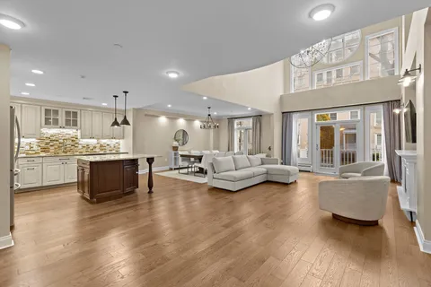 a living room with furniture and kitchen view