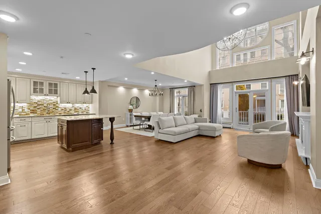 a living room with furniture and kitchen view