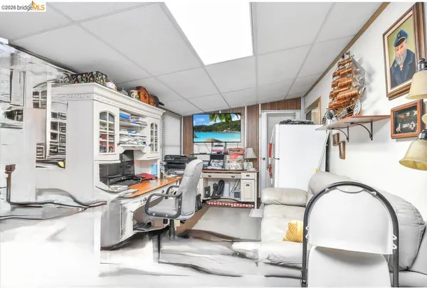a room with lots of furniture and white walls