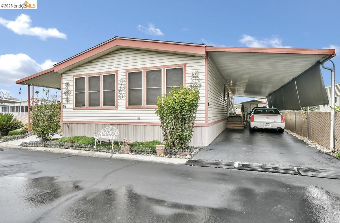 4603 Balfour Road, Unit 86 Brentwood, CA 94513 - Photo 3 of 24 View of side of home featuring an attached carport and driveway
