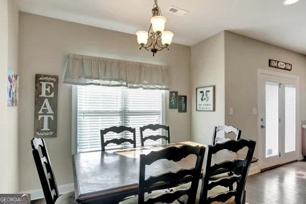 a en suite bathroom with a granite countertop sink and a mirror