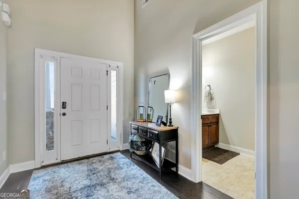 a bedroom with a large bed and a tv