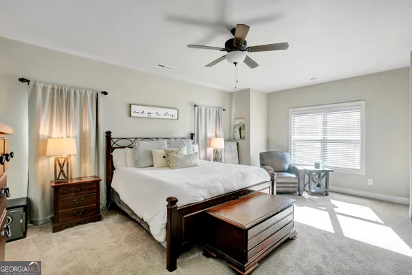 a spacious bathroom with a tub sink double vanity and mirror