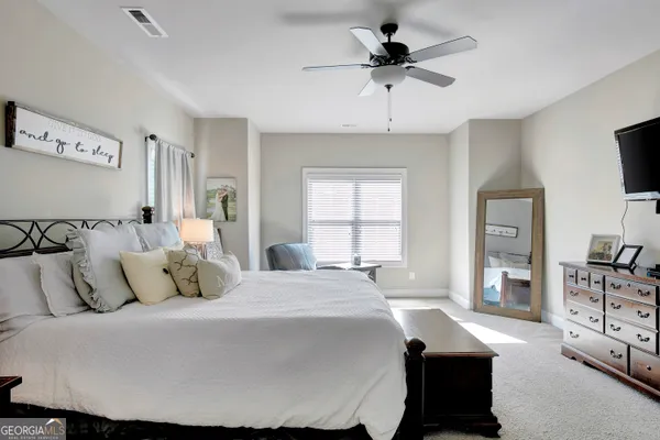 a bathroom with a tub a sink and a window