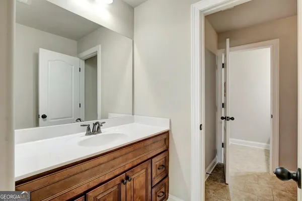 a view of a hallway with wooden floor and windows