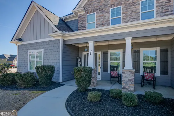 a view of a hallway with bathroom and wooden floor