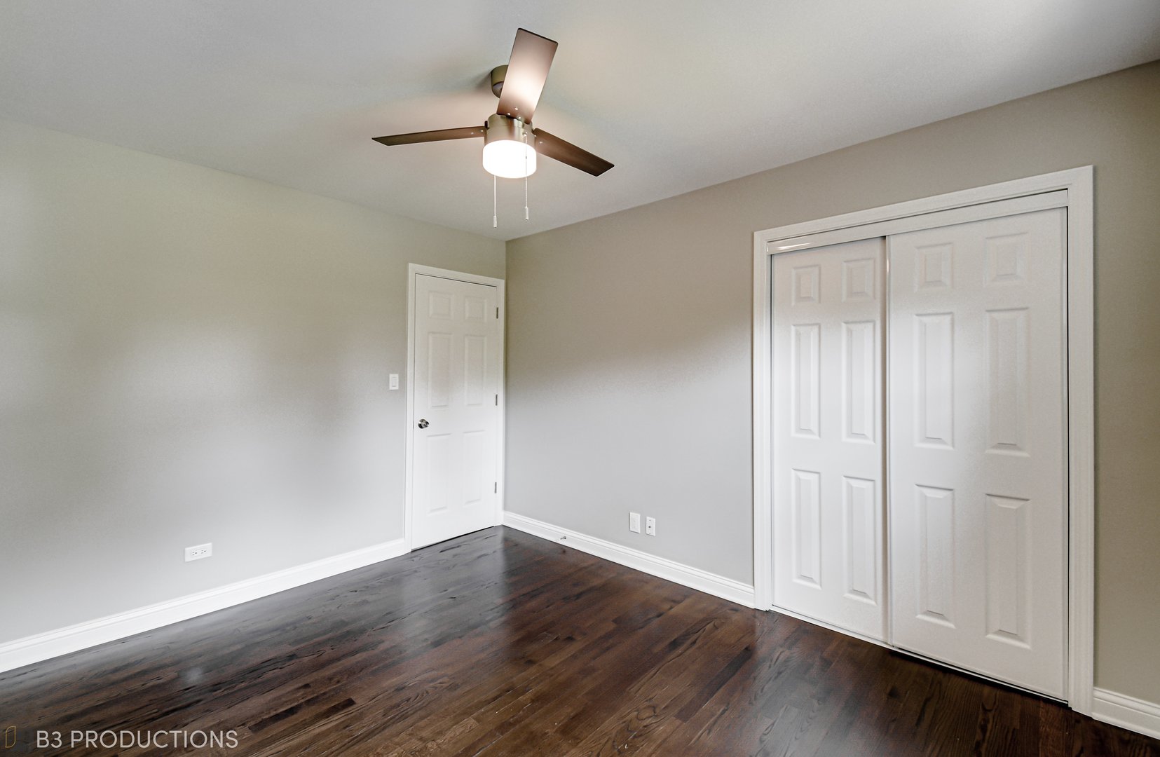 719 Jefferson Street Crete, IL 60417 - Photo 11 of 14 an empty room with wooden floor chandelier fan and windows