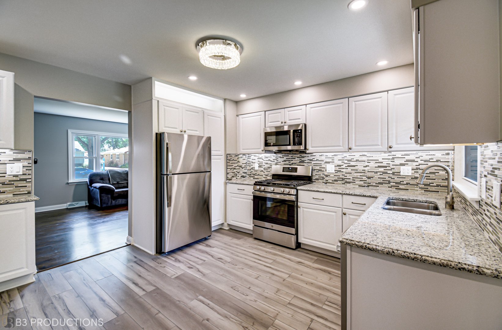 719 Jefferson Street Crete, IL 60417 - Photo 6 of 14 a kitchen with granite countertop stainless steel appliances a refrigerator a stove top oven a sink and dishwasher