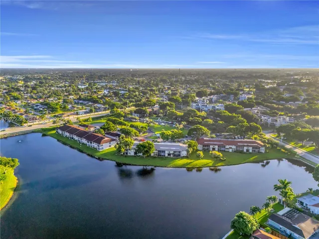 an aerial view of residential houses with outdoor space and swimming pool