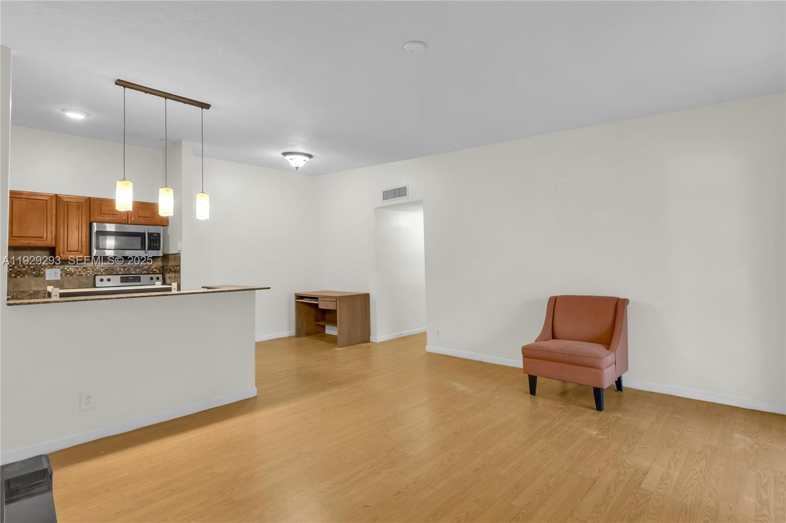 9415 West McNab Road, Unit 204 Tamarac, FL 33321 - Photo 3 of 20 a living room with furniture and kitchen view