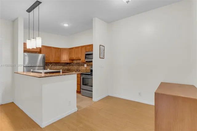 a kitchen with stainless steel appliances a refrigerator and a stove