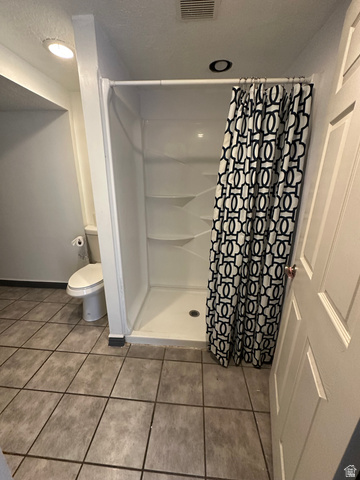 8320 West 3100th Street South Magna, UT 84044 - Photo 23 of 41 Full bath featuring a stall shower and light tile patterned floors