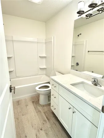 a bathroom with a sink a toilet and a bathtub