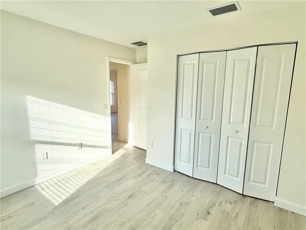 a view of hallway with wooden floor